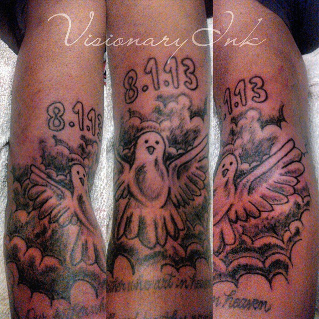 Doves with dates tattoo on the thigh by Visionary Ink