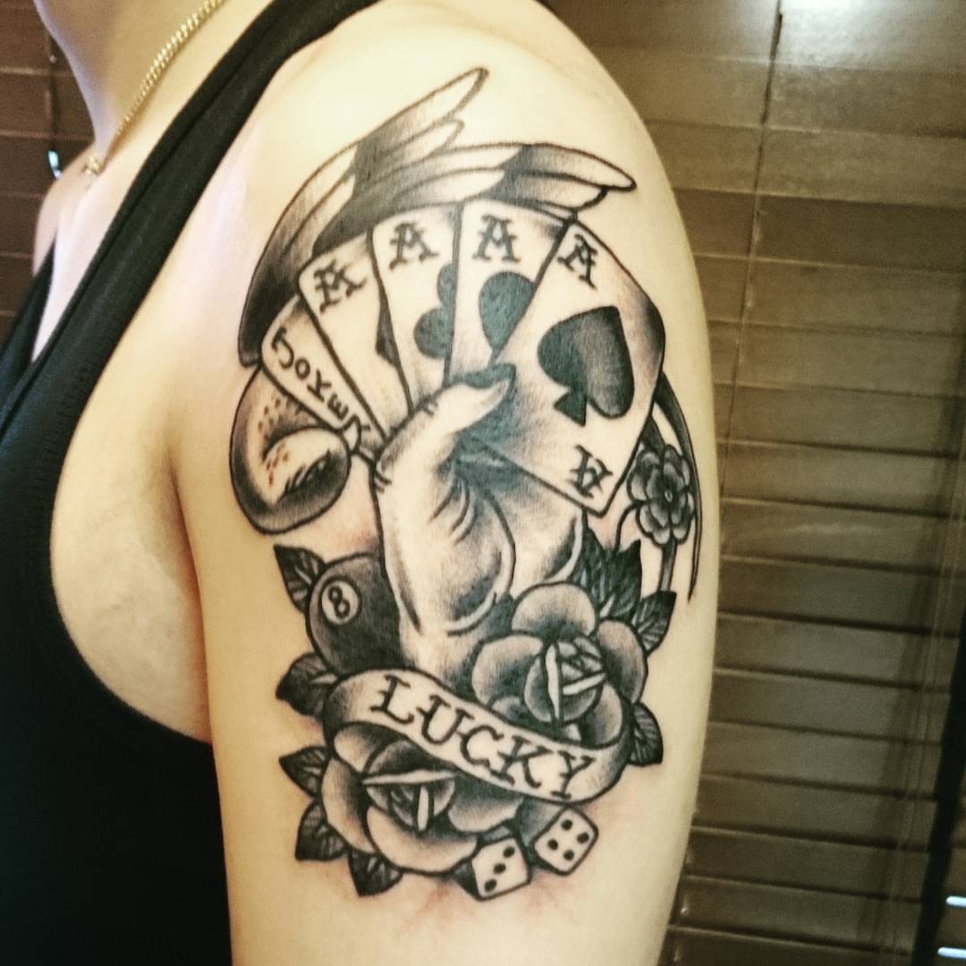 Playing cards and dice American traditional tattoo on the shoulder by Daichi Horiyama