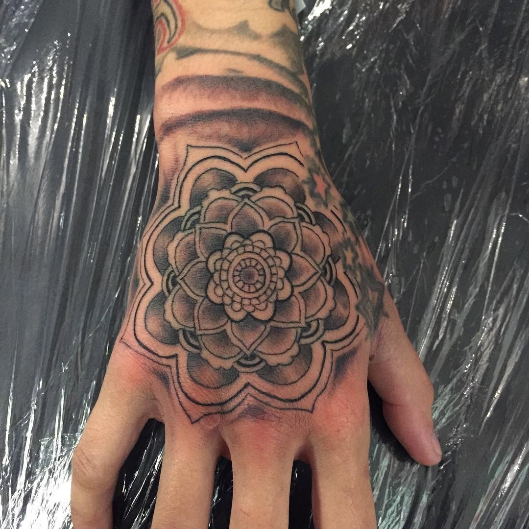 Mandala geometric tattoo on the hand by Chris