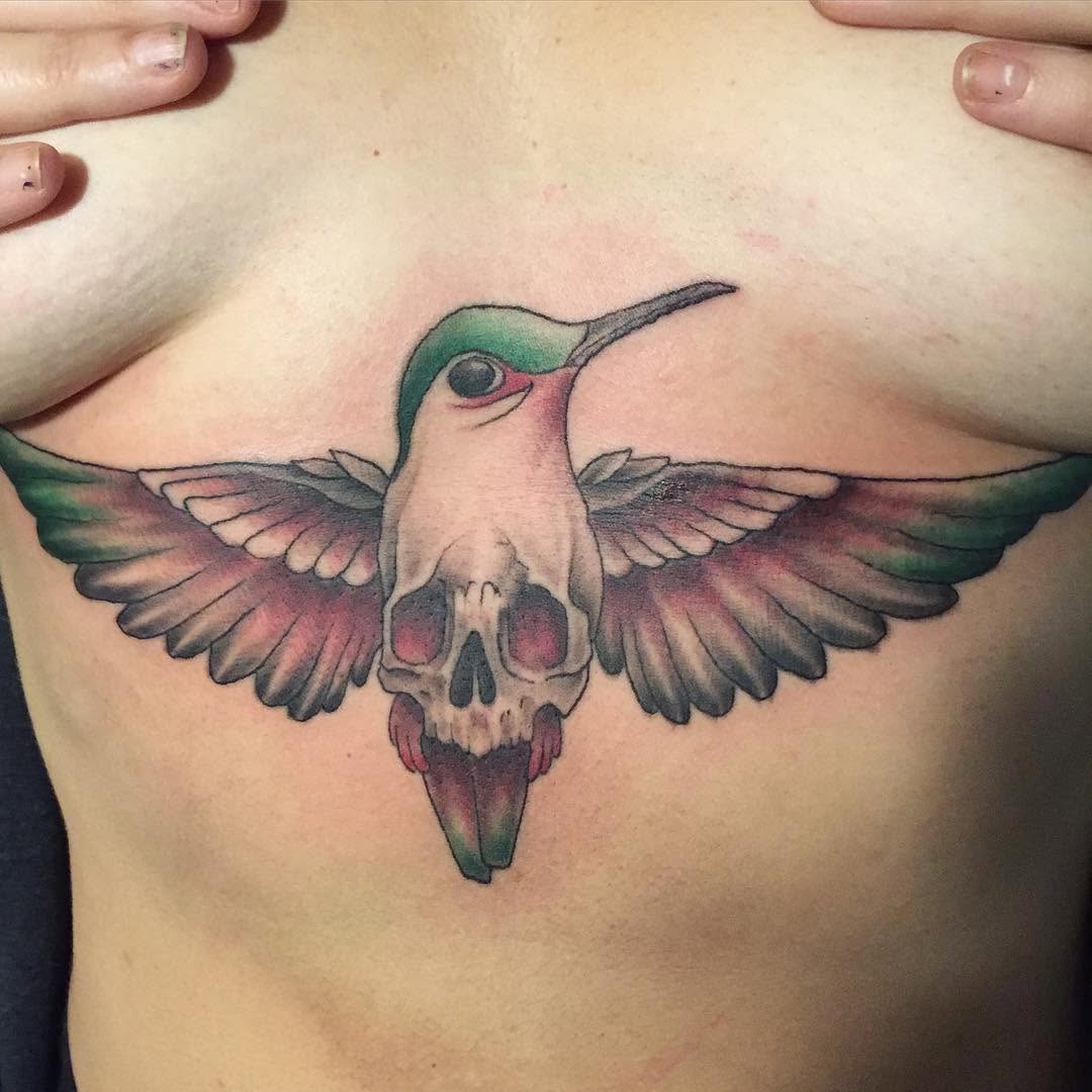 Hummingbird skull hybrid watercolor tattoo on the chest by Chris