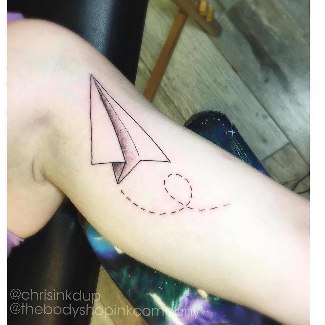 Paper airplane minimalist tattoo on the forearm by Chris