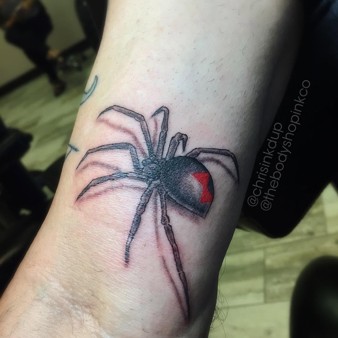 Black widow spider blackwork tattoo on the forearm by Chris
