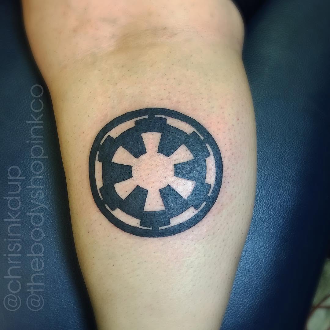 Imperial cog tattoo on the forearm by Chris