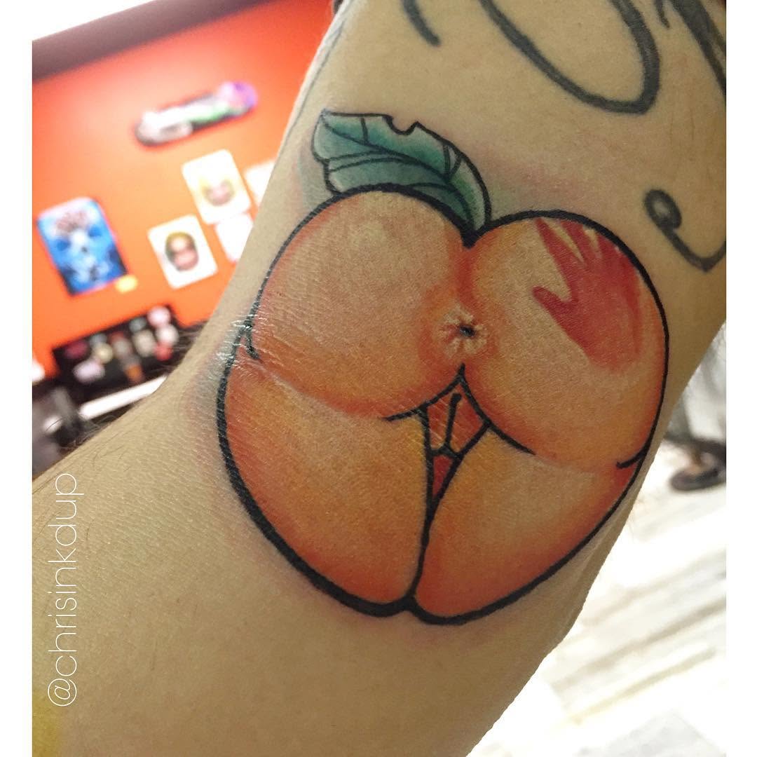 Peach butt tattoo on the forearm by Chris