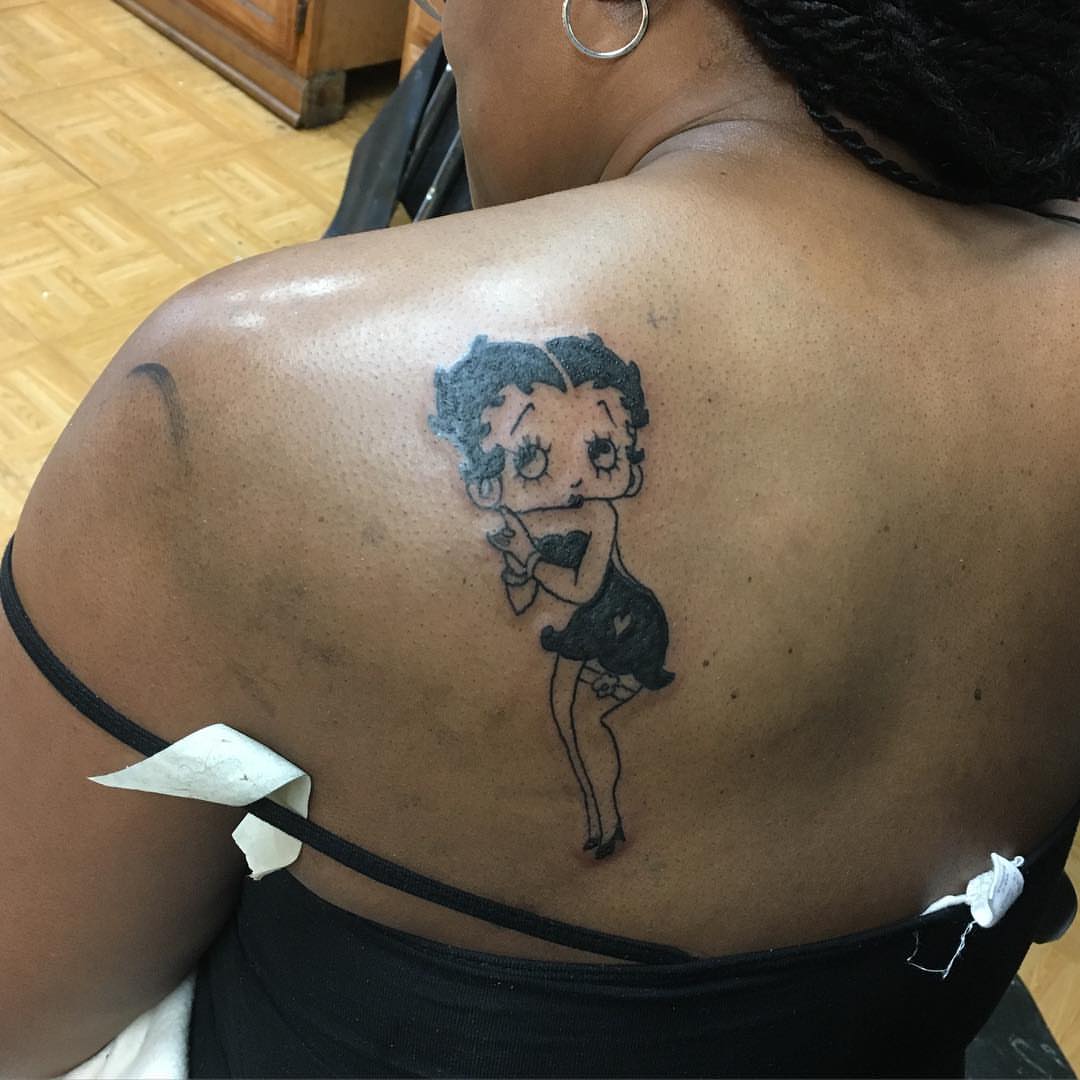 Betty Boop black and grey tattoo on the back by Rashaun Collins