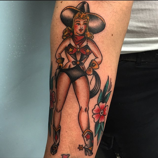 Cowgirl pin-up American traditional tattoo on the forearm by Dave G