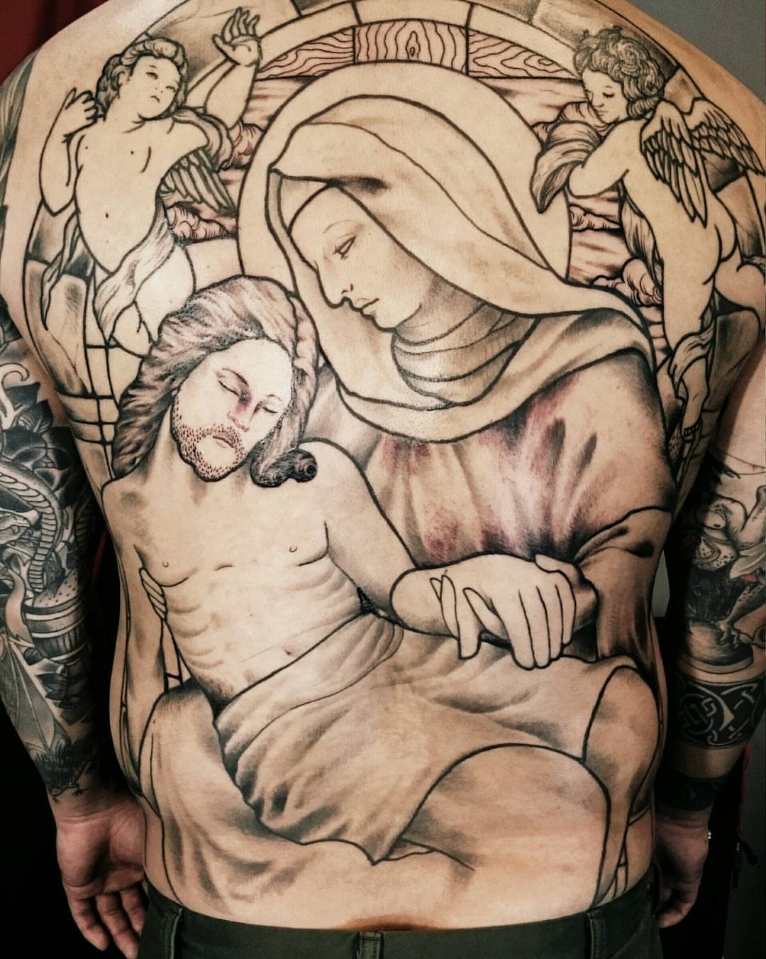 Pieta realism tattoo on the torso by Daichi Horiyama