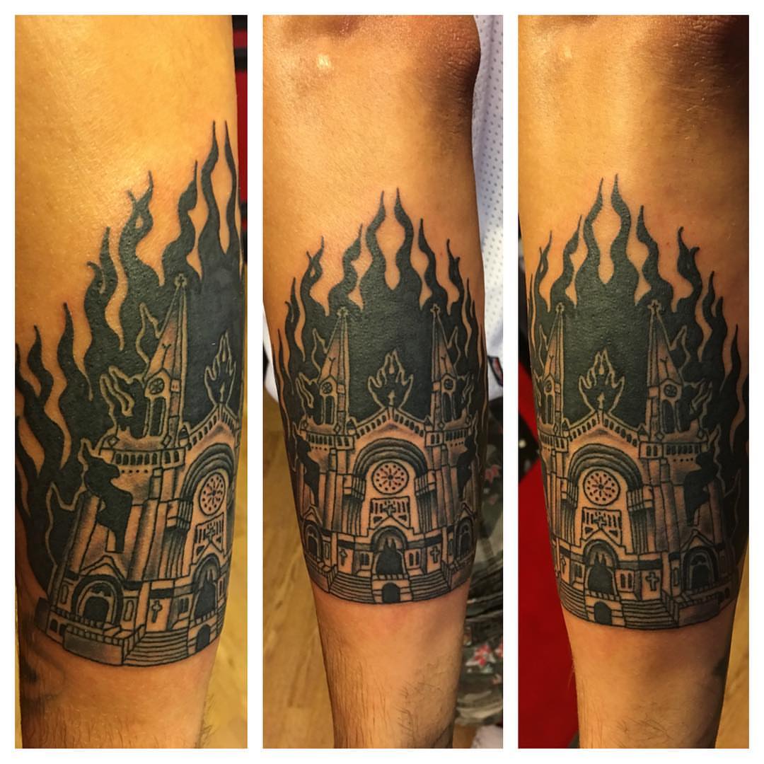 Burning cathedral black and grey tattoo on the forearm by Zac Presley