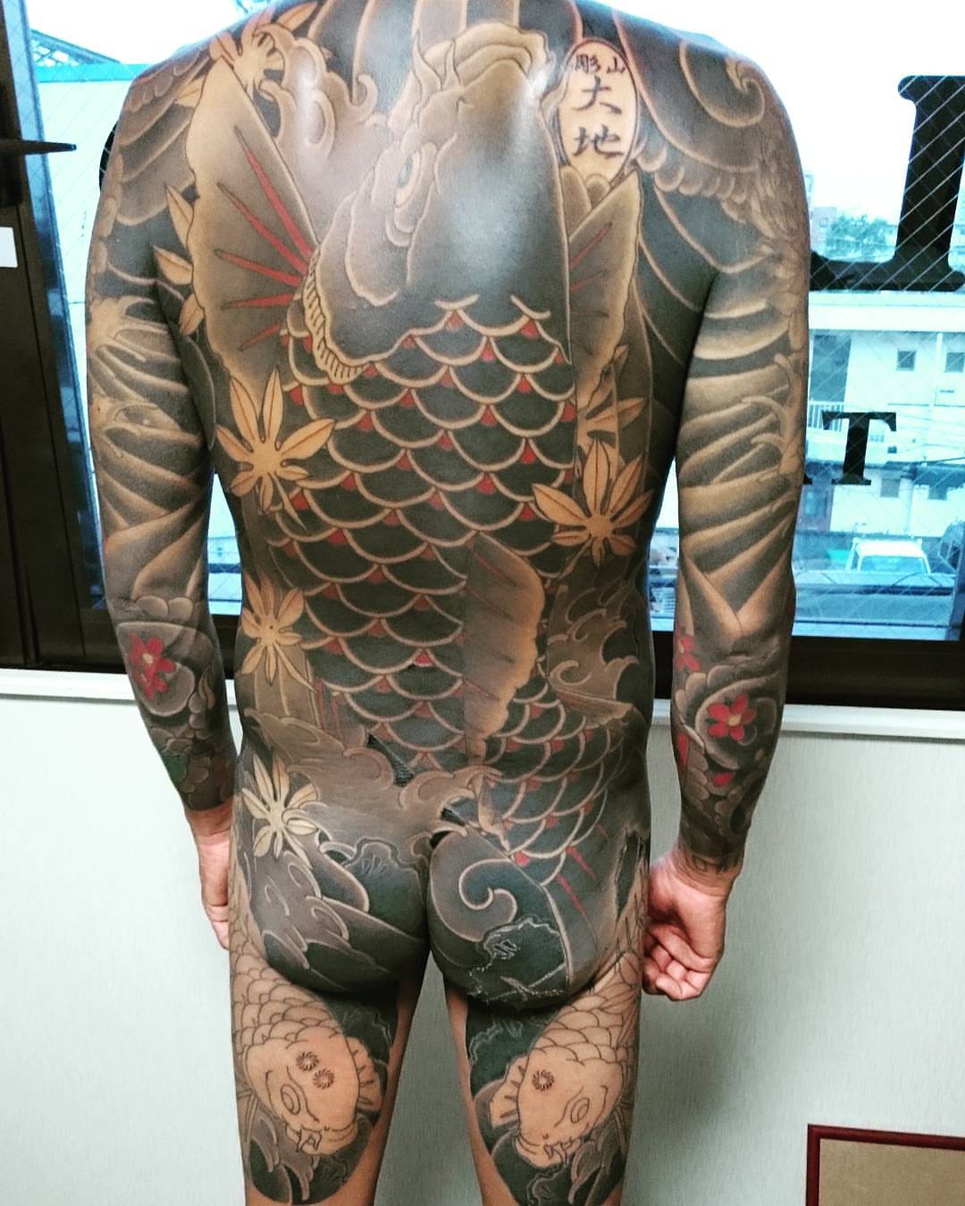 Koi fish japanese irezumi tattoo on the back by Daichi Horiyama