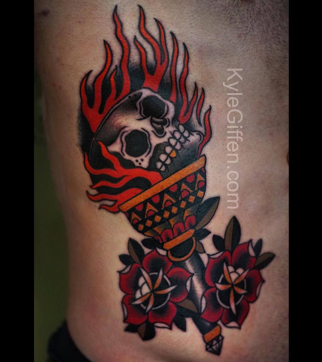 Flaming skull with roses American traditional tattoo on the thigh by Kyle Giffen - Tattoo Artist