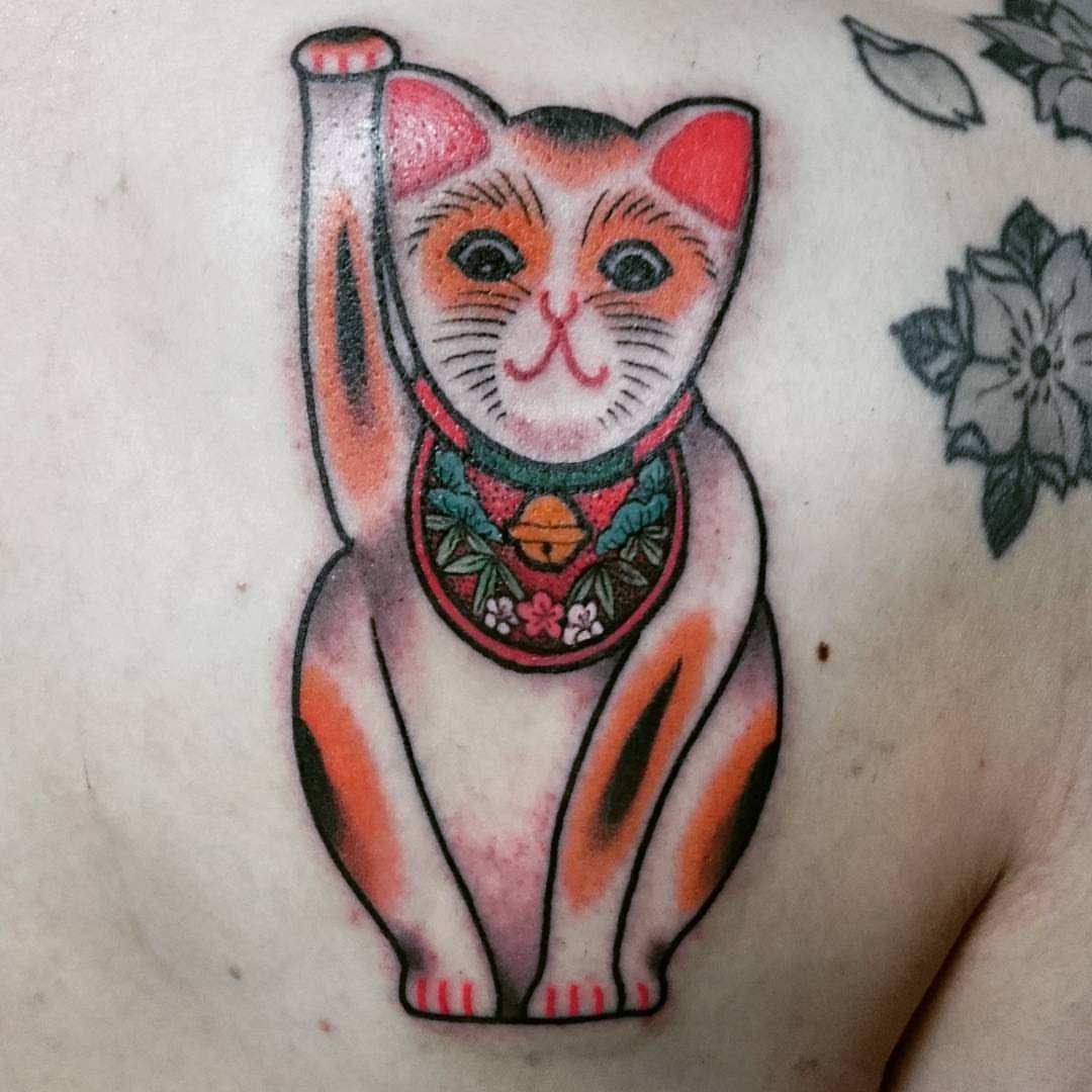 Maneki-neko American traditional tattoo on the chest by Daichi Horiyama