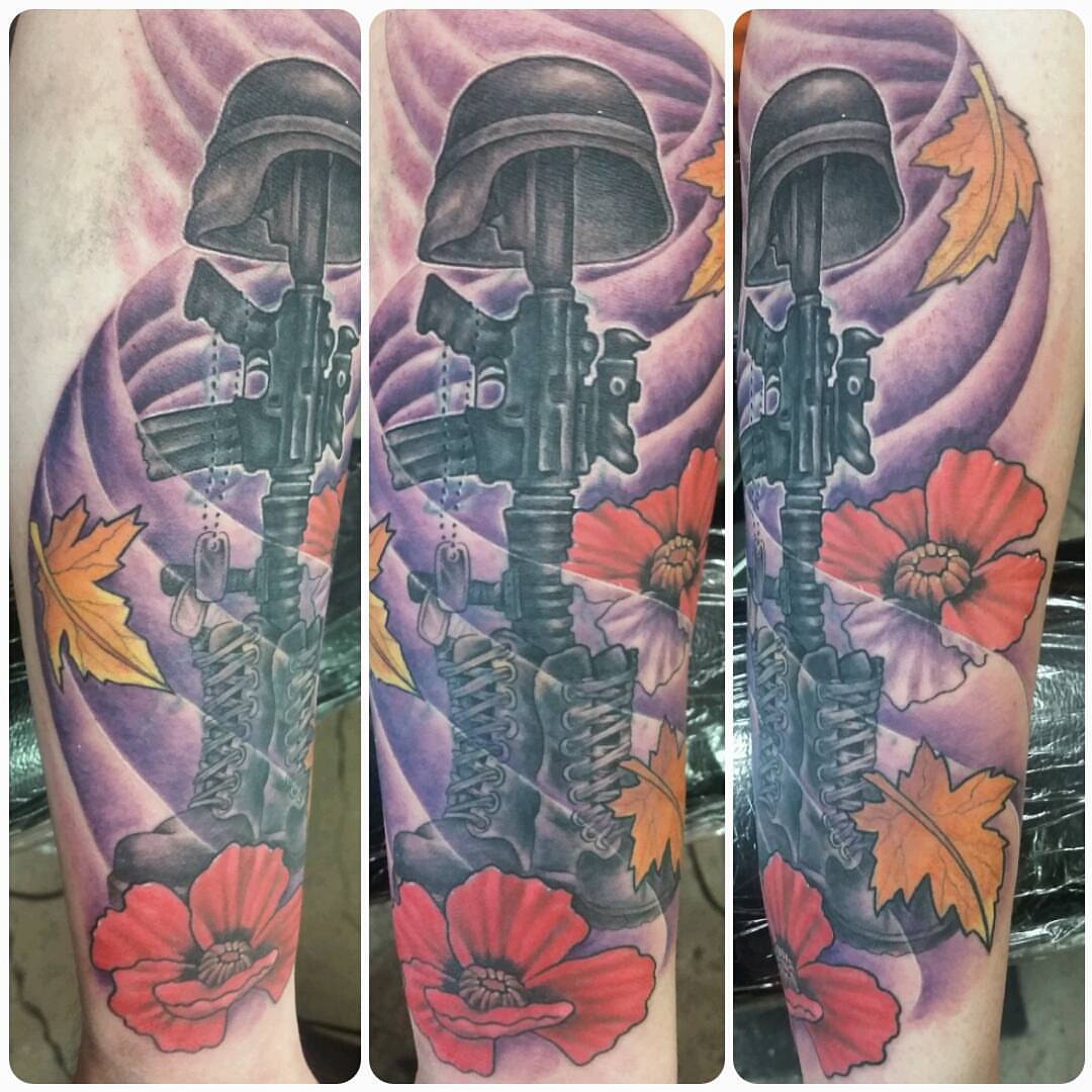 Military helmet and rifle realism tattoo on the forearm by Dustin Lane Collins