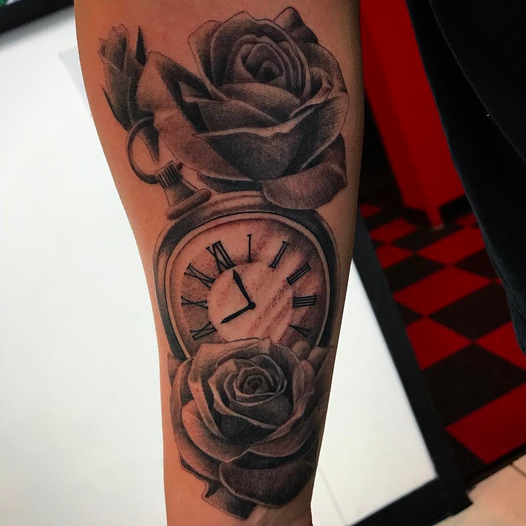 Clock and roses realism tattoo on the forearm by Jared Ammons