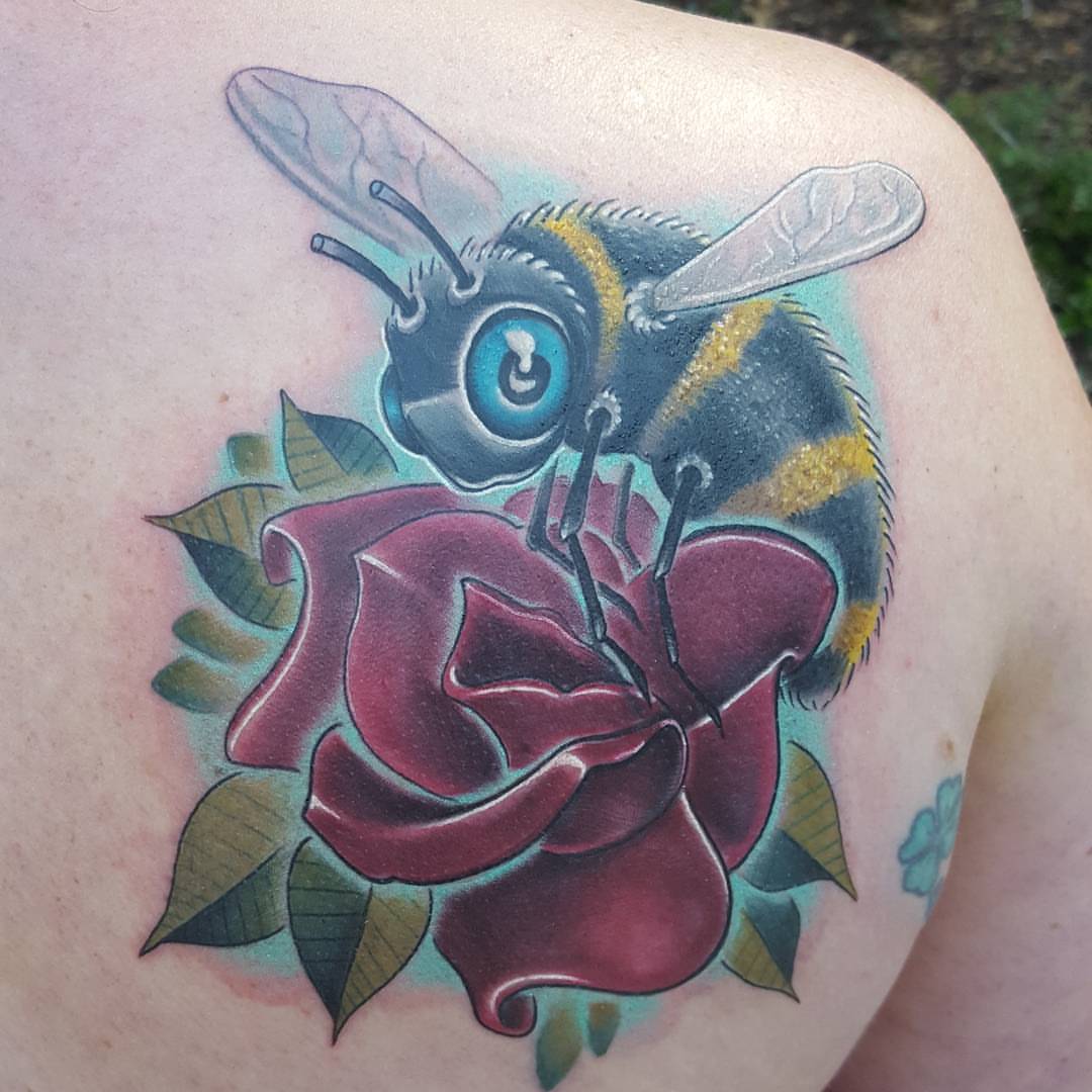 Bee and rose American traditional tattoo on the shoulder by Jon Goad
