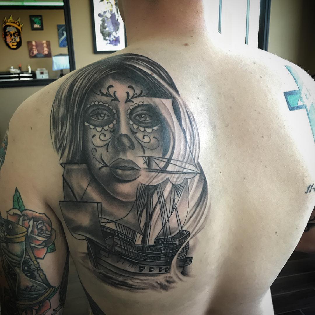 Sugar skull with ship realism tattoo on the back by Joe Shepp