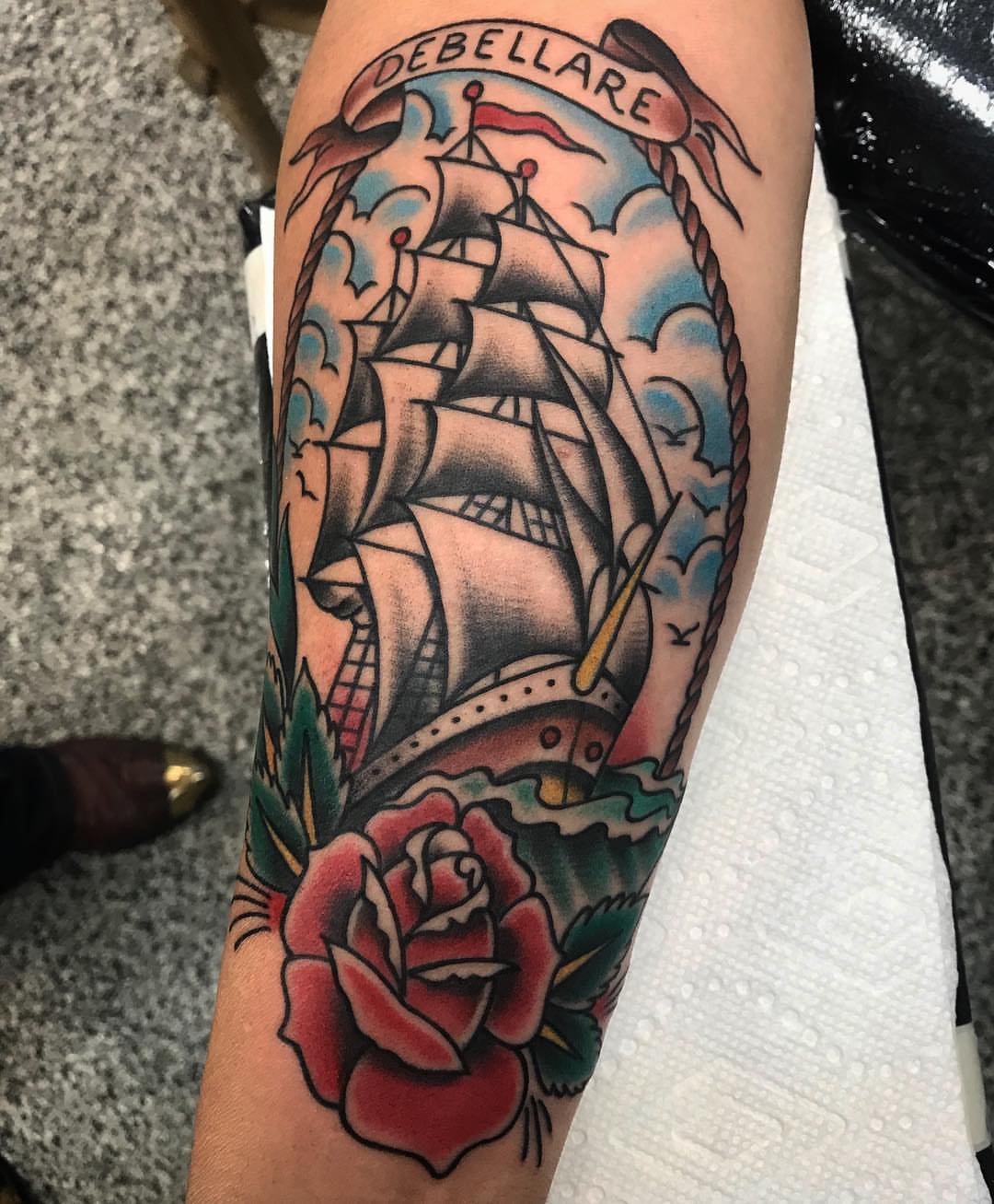 Sailboat and rose American traditional tattoo on the forearm by Dave G