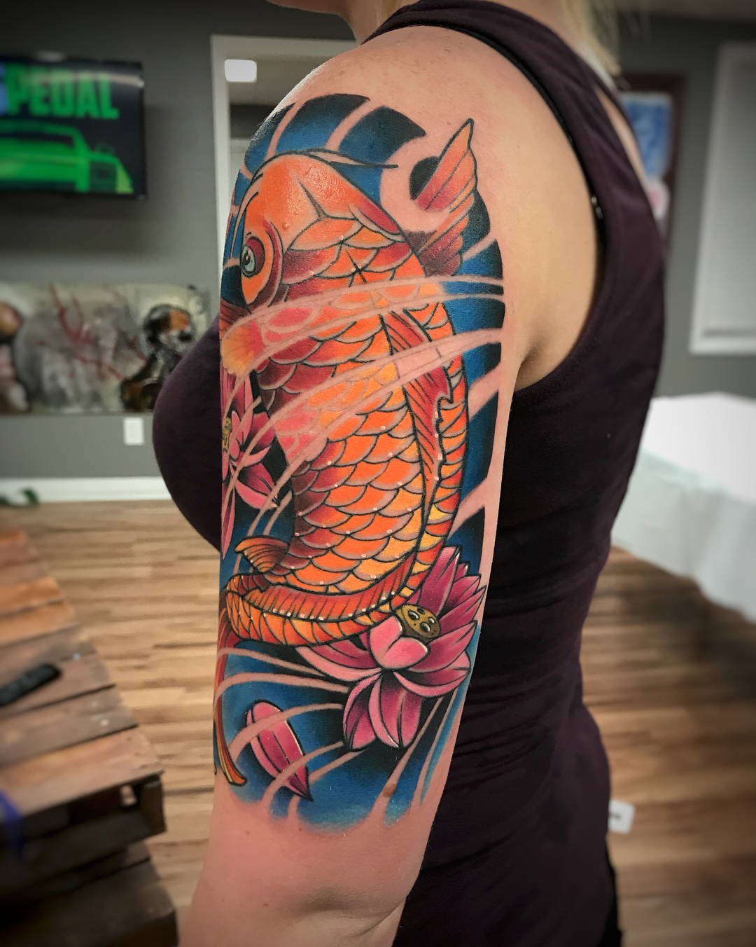 Koi fish and lotus japanese irezumi tattoo on the upper arm by Derek Hutchison, Des Moines, Iowa