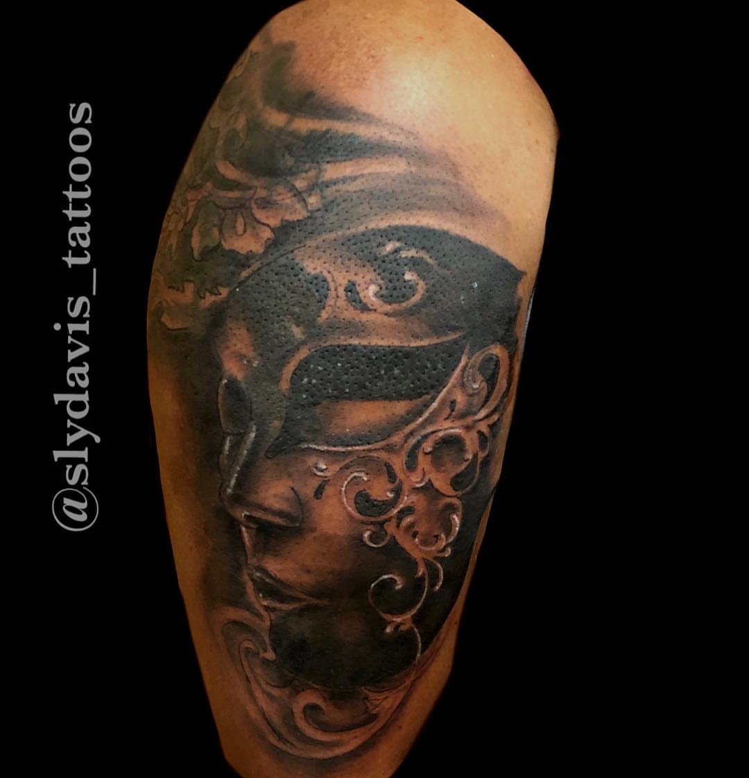 Mask realism tattoo on the forearm by Sly Davis