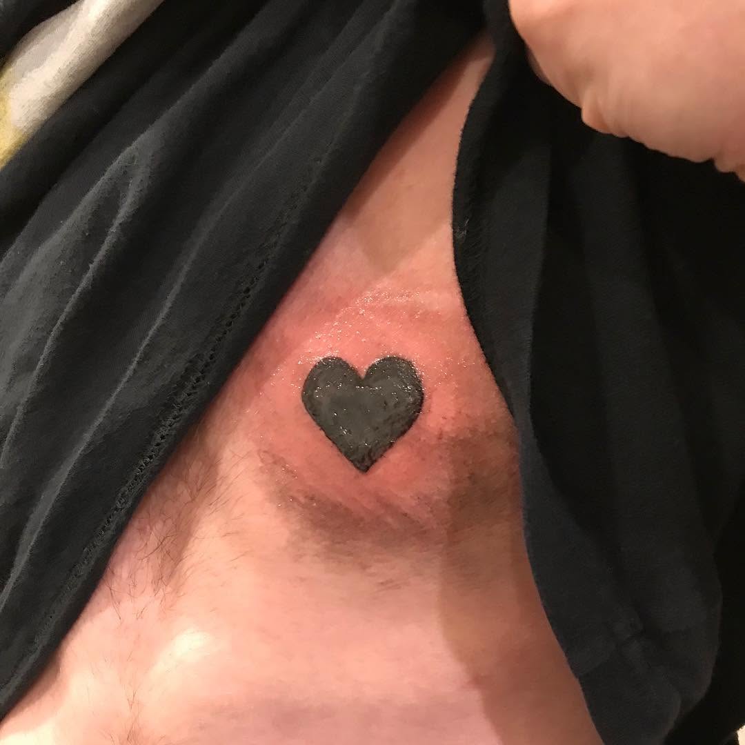 Black heart ignorant tattoo on the chest by @beantowntats