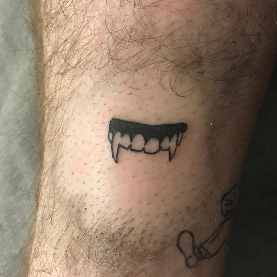 Vampire fangs dark art tattoo on the forearm by @beantowntats