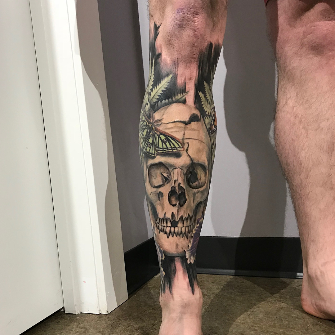 Skull with butterfly realism tattoo on the calf by Jacoba Kaufman