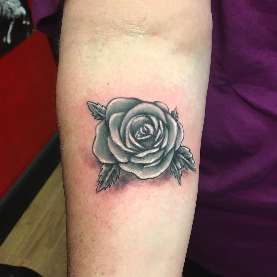 Rose black and grey tattoo on the forearm by Zac Presley