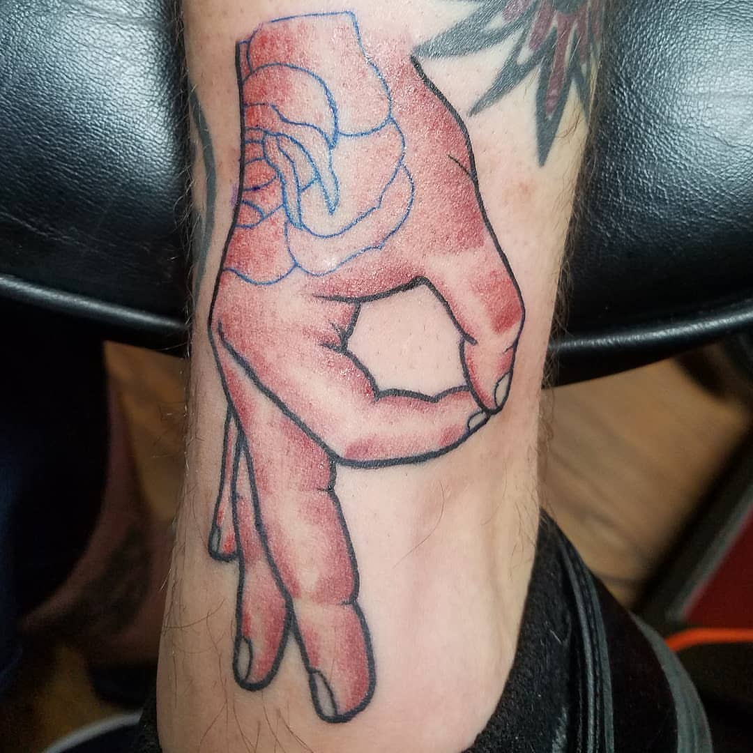 Hand gesture American traditional tattoo on the forearm by Dick Eckman
