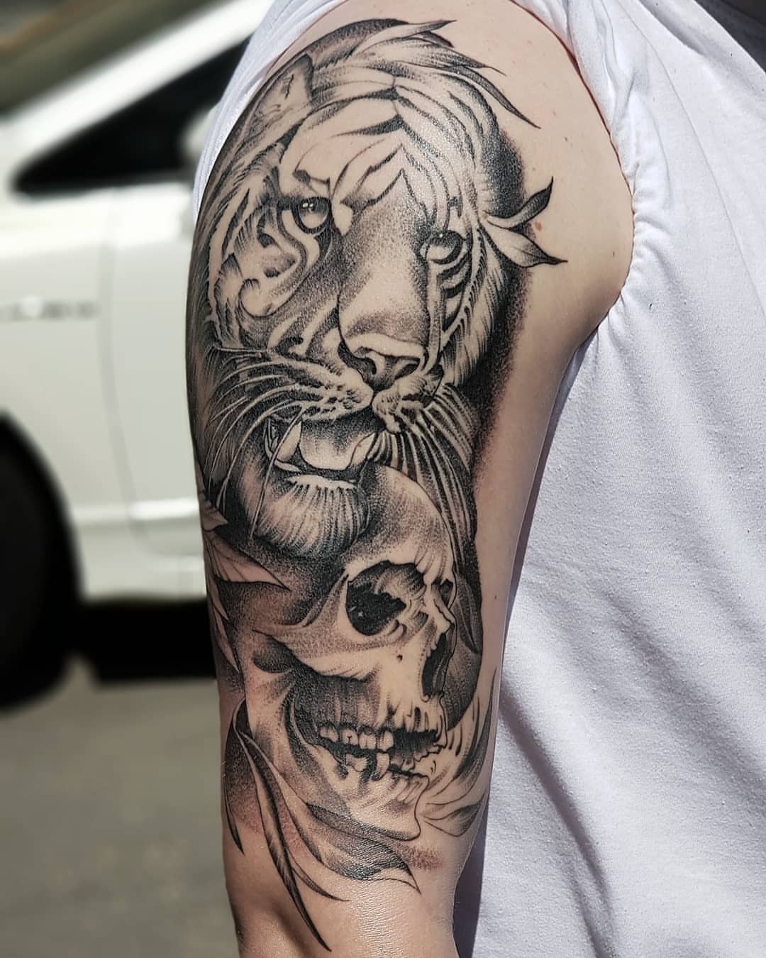 Tiger and skull realism tattoo on the forearm by Nikita Grinenko, San Francisco