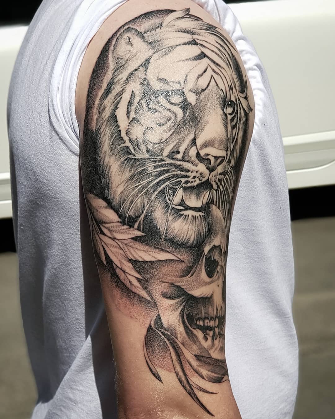 Tiger and skull dotwork tattoo on the forearm by Nikita Grinenko, San Francisco