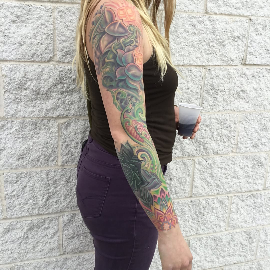 Floral design new school tattoo on the upper arm by Phil Robertson