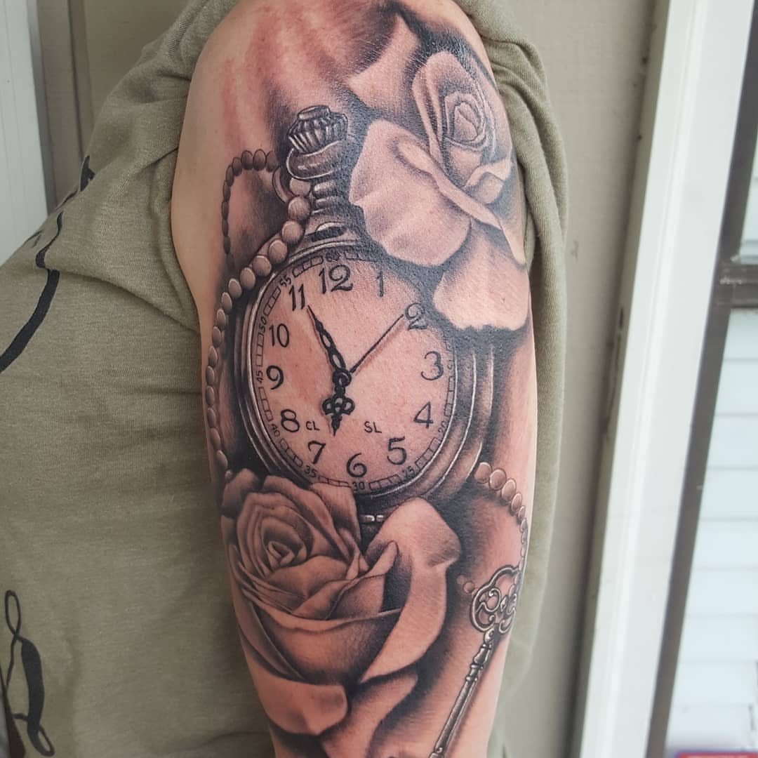 Clock and roses realism tattoo on the forearm by Jon Goad