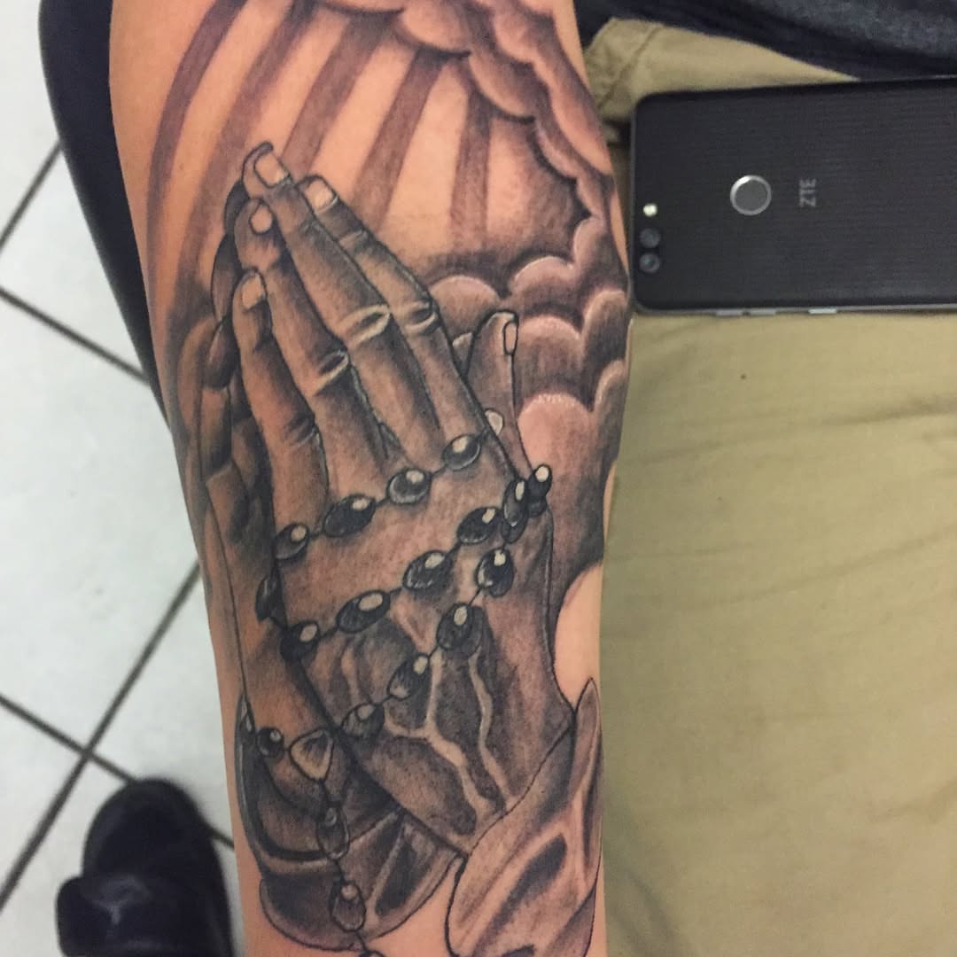 Praying hands realism tattoo on the forearm by Junior Trevino