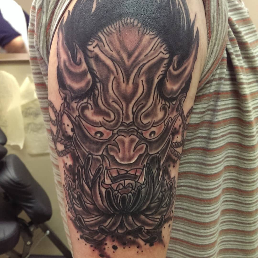 Demon mask dark realism tattoo on the forearm by Rue McLean