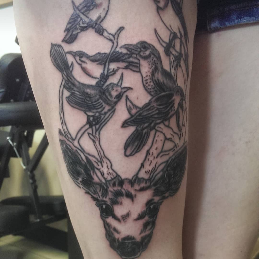 Deer head with birds black and grey tattoo on the forearm by Rue McLean