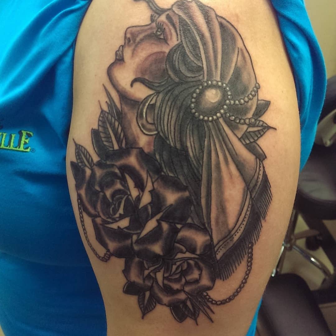 Woman with roses American traditional tattoo on the shoulder by Rue McLean