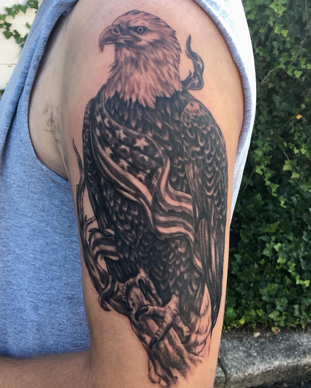 Eagle realism tattoo on the upper arm by Comfy Chris Fettig