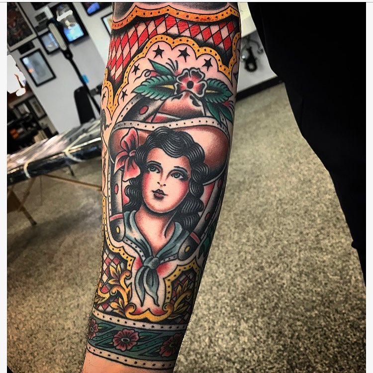 Woman with floral crown American traditional tattoo on the forearm by Dave G