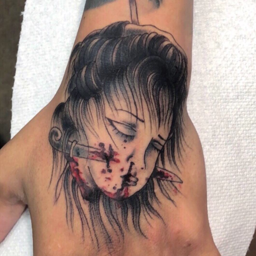 Woman with headphones realism tattoo on the hand by Danielle Dubois