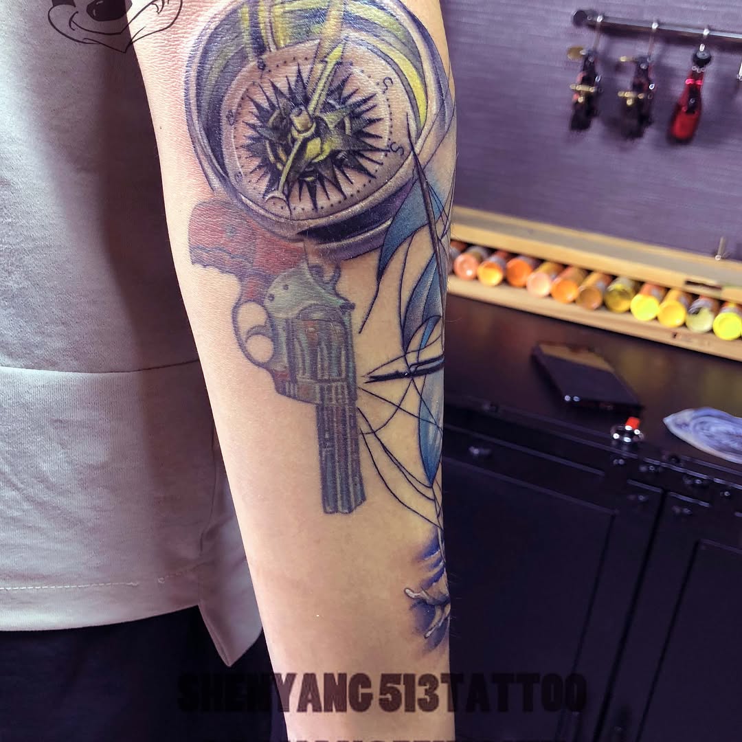 Compass and gun tattoo on the forearm by 中国🇨🇳沈阳513TATTOO