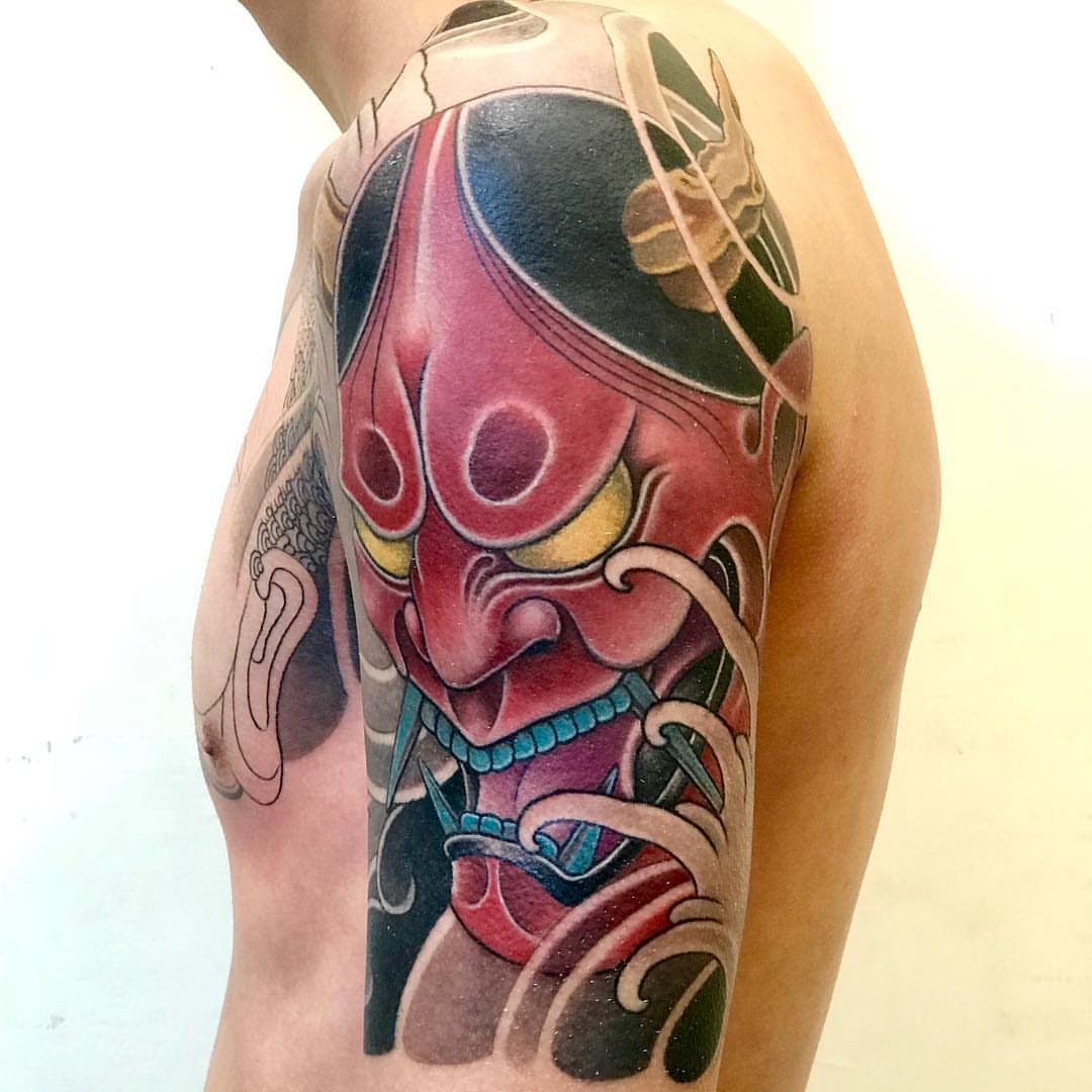 Demon mask japanese irezumi tattoo on the upper arm by 重君