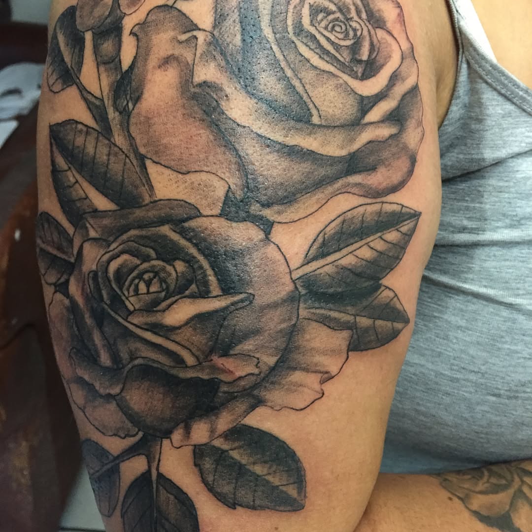 Roses black and grey tattoo on the forearm by Junior Trevino