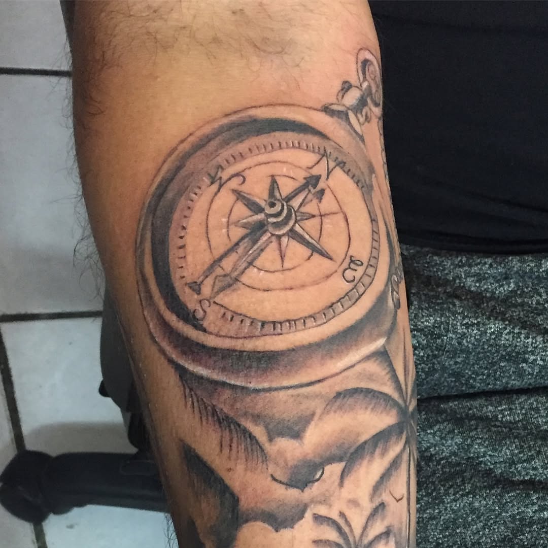 Compass black and grey tattoo on the forearm by Junior Trevino