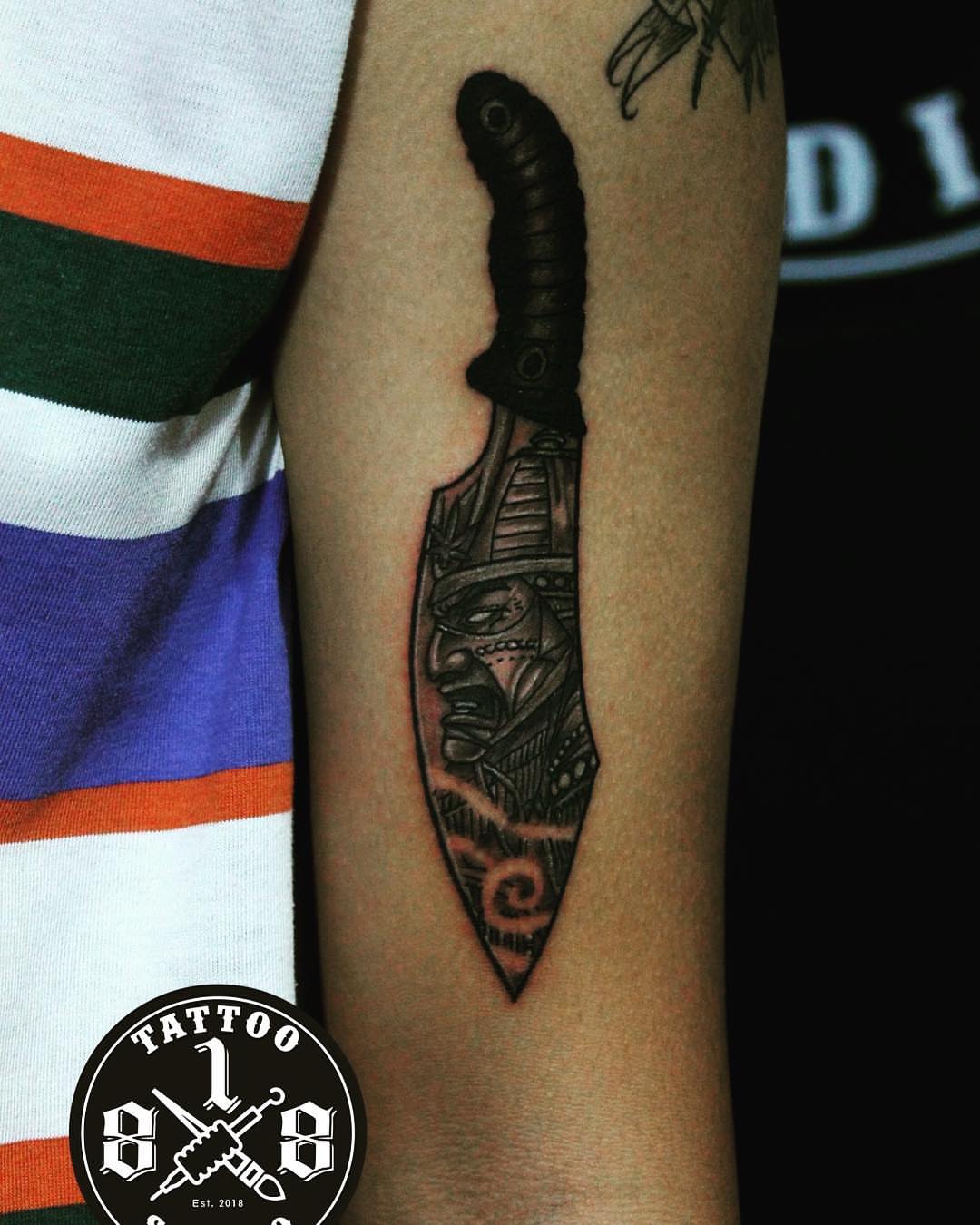 Knife with Egyptian figure realism tattoo on the forearm by Ferds Villanueva