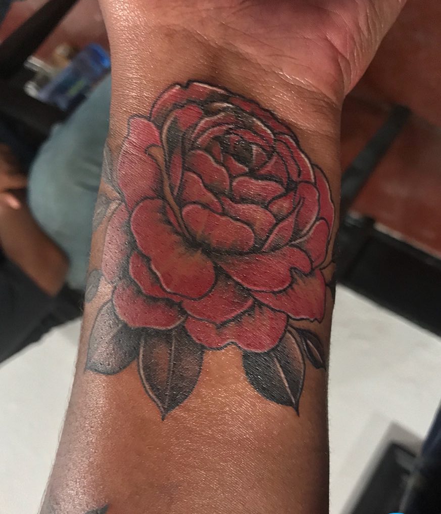 Red rose American traditional tattoo on the forearm by Felix 🔸 Chesto (Tattooers)