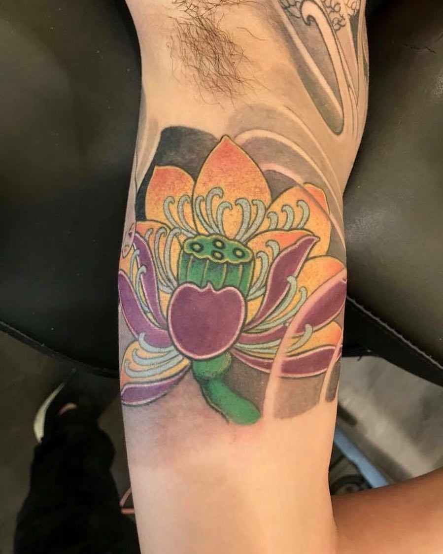 Lotus flower new school tattoo on the forearm by 重君