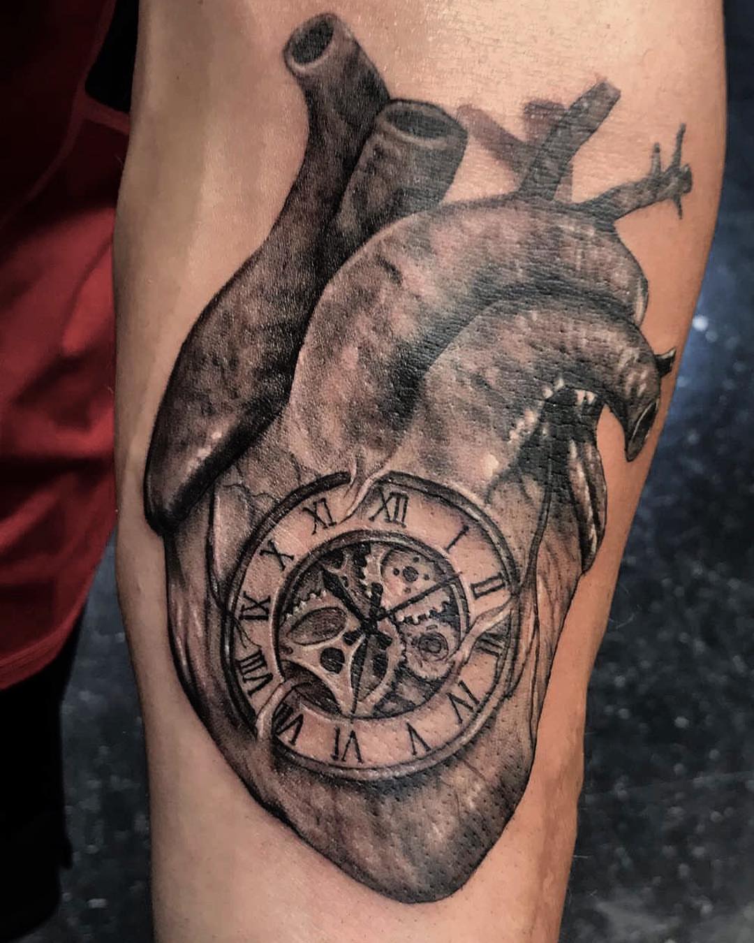 Heart with clock realism tattoo on the forearm by Aaron Watson