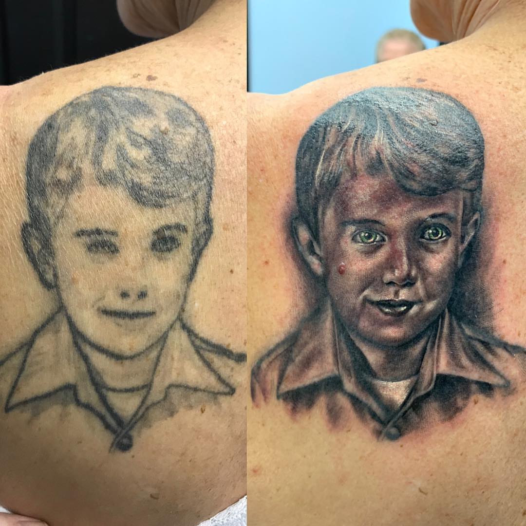 Child portrait realism tattoo on the back by Trevor Sibary