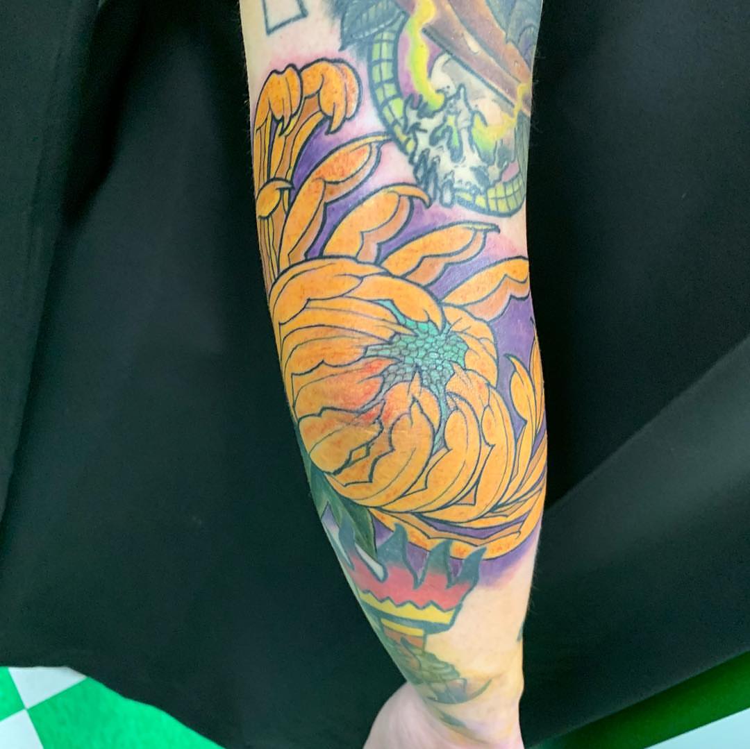 Sunflower American traditional tattoo on the forearm by Jason L.