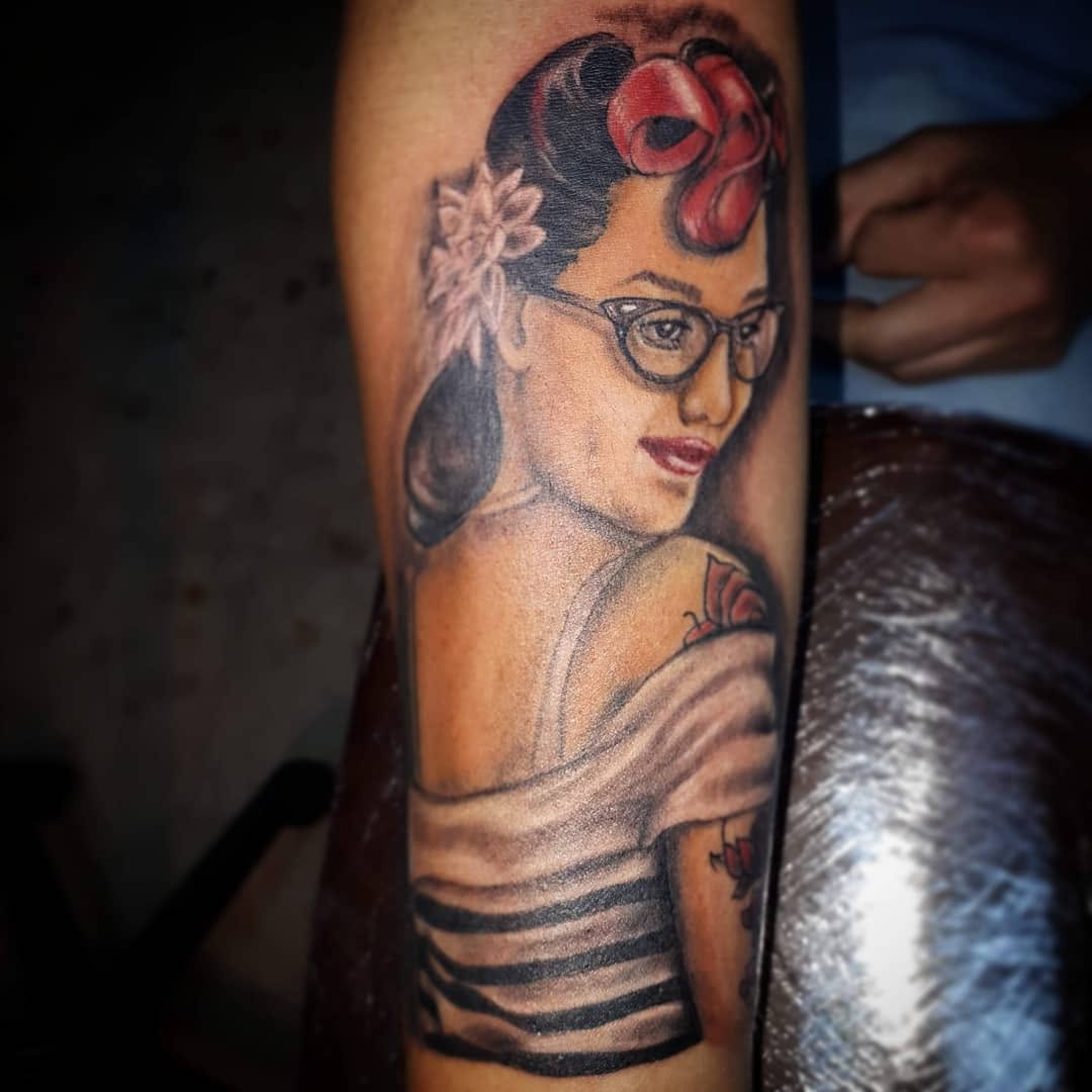 Pin-up girl with glasses neo-traditional tattoo on the forearm by 212tattoomalaga, Málaga, Spain