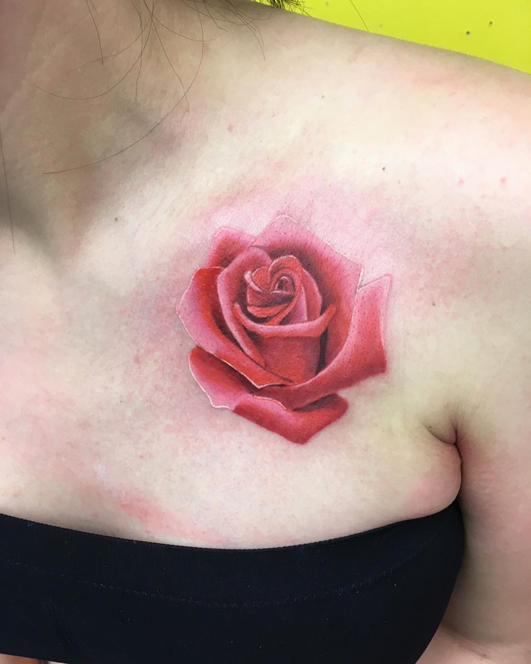 Red rose realism tattoo on the chest by Herc